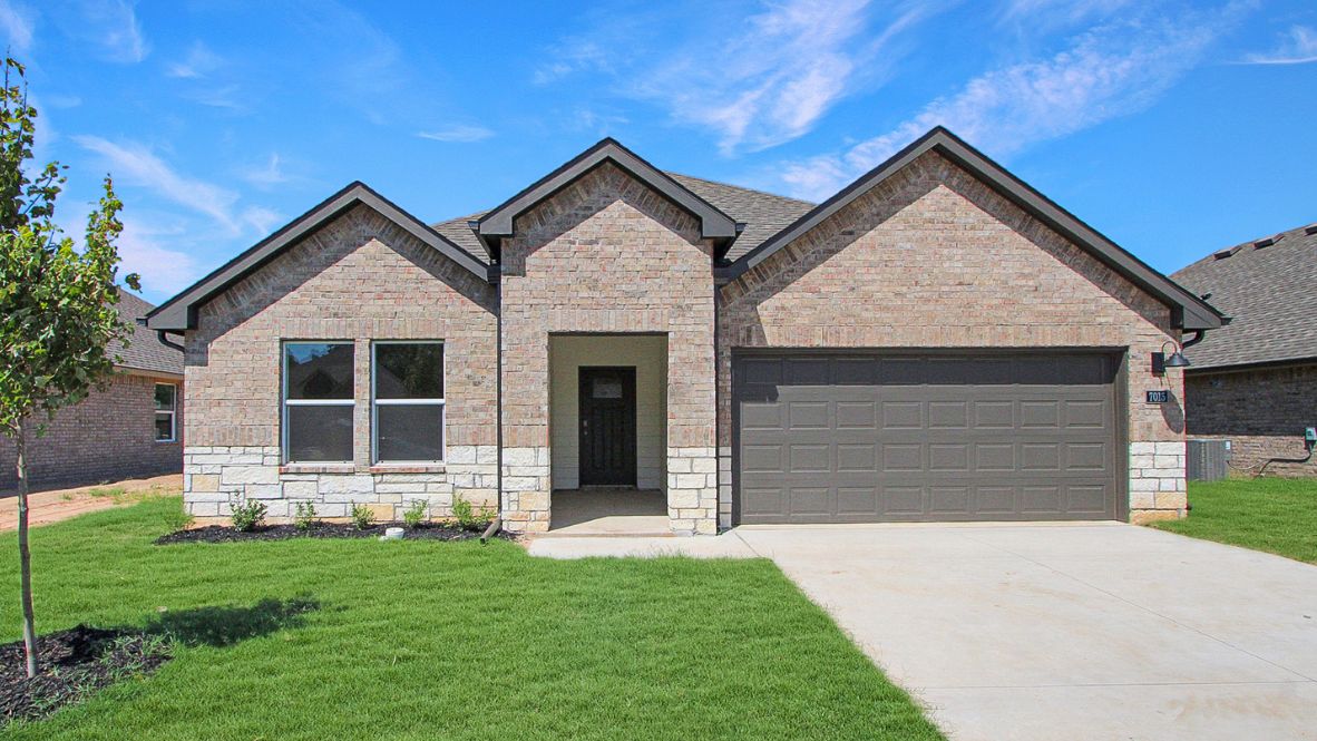 View showcasing Holden Plan’s 3-car garage, front yard, and clean exterior design