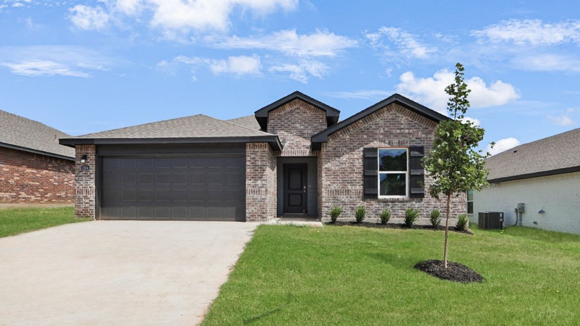 Front view showcasing 2-car garage, front yard, and clean exterior design