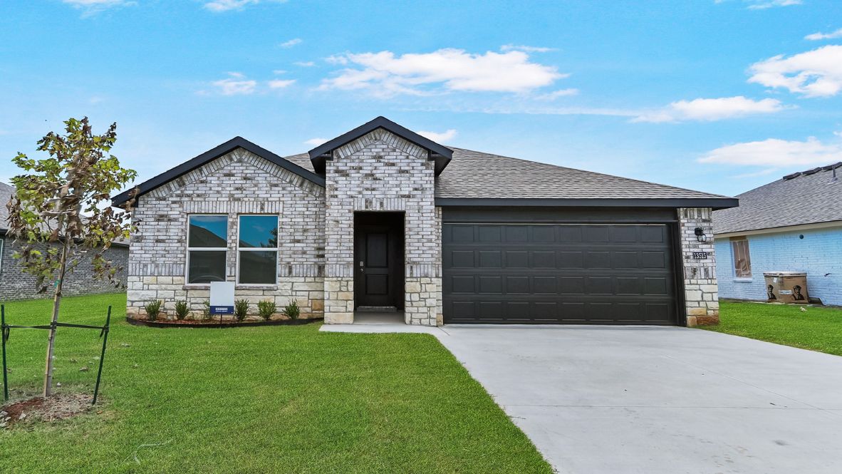 Exterior sidewalk view highlighting façade, entry path, and front yard