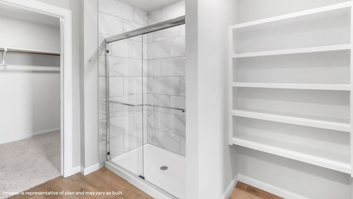 Owner’s ensuite featuring dual vanity sinks, stylish finishes, and walk-in closet access Estates at Ridgewood