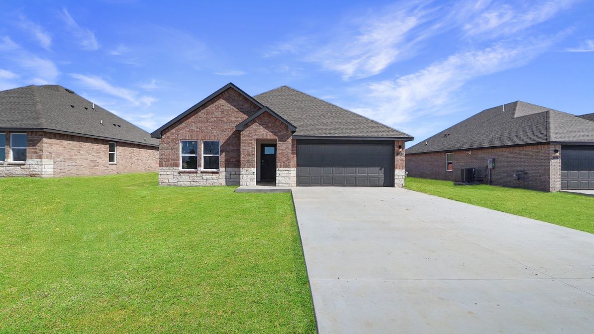 Street view of Justin plan with landscaped front yard and architectural details