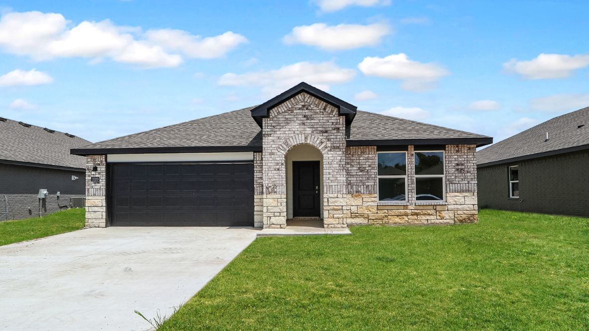 Street view of exterior elevation with driveway and front windows