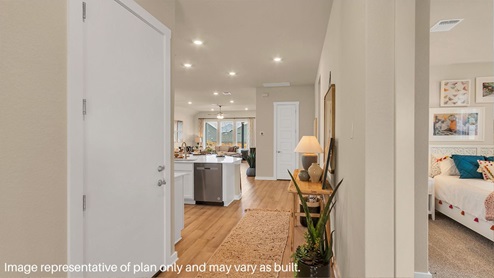 Entry hallway leading to living room and kitchen in the background.