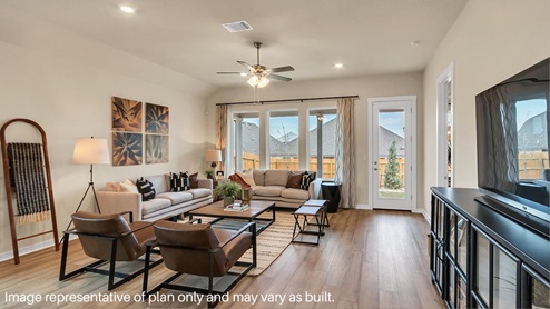 A cozy living room featuring a comfortable couch, a stylish coffee table, and an elegant painting on the wall.
