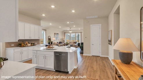 Bright and spacious kitchen with granite countertops, stainless steel appliances, and an island with bar seating.
