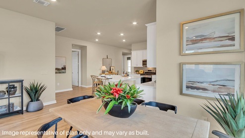 Spacious dining area with vinyl wood flooring, large window and tall ceiling.