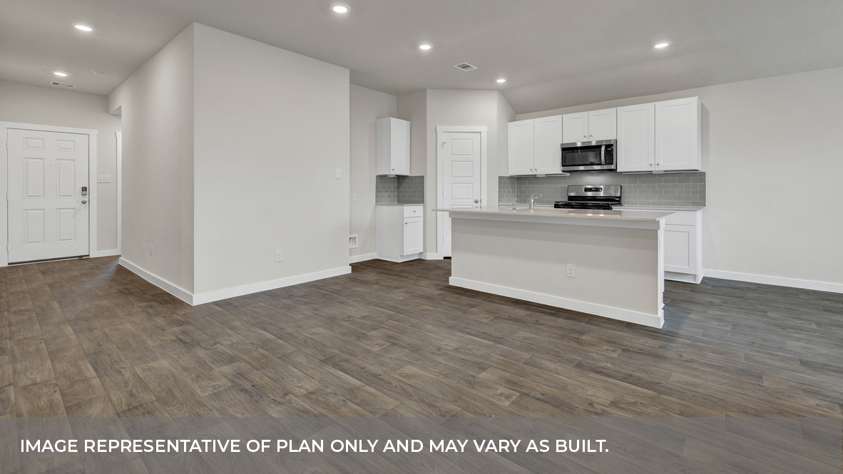 Contemporary kitchen adorned with white cabinets seamlessly integrated into an open dining area layout.
