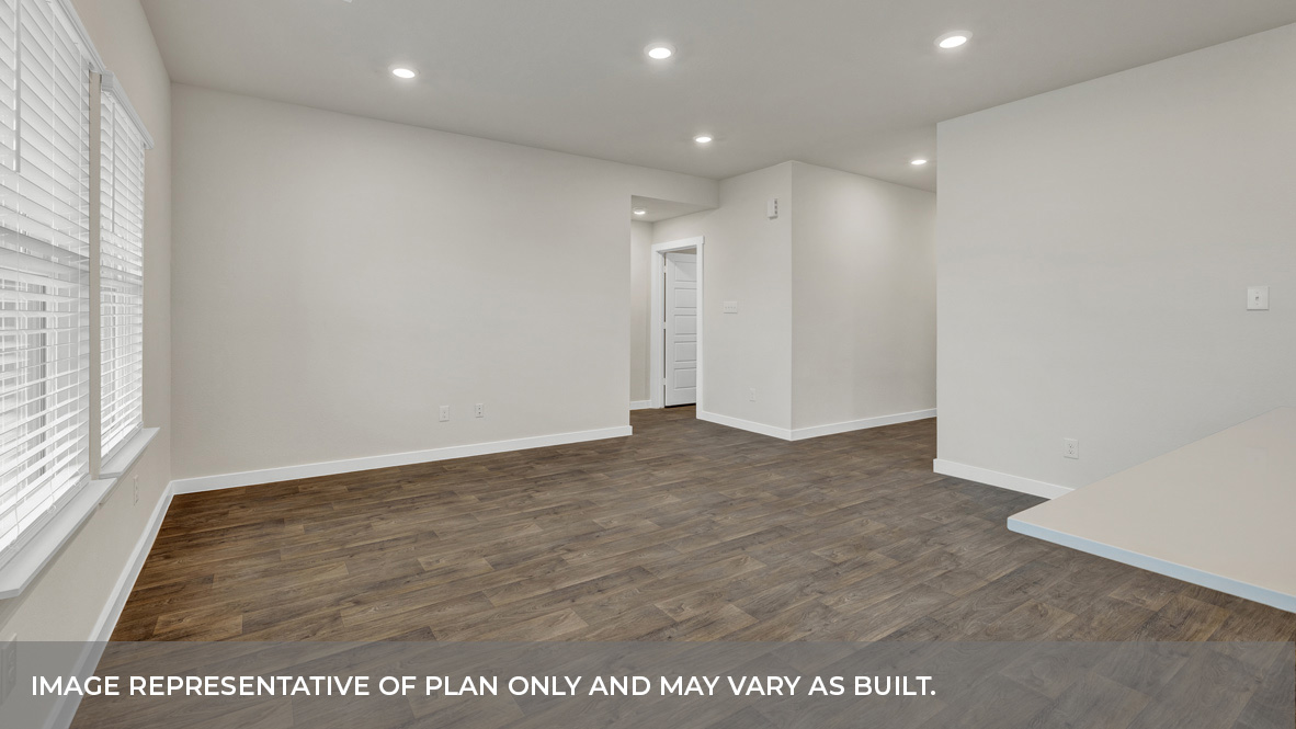 A well-organized living room that includes a kitchen and dining area, creating a warm and welcoming environment for gatherings.