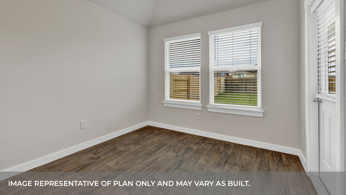Formal dining room with large windows, vinyl wood floors, and view of the backyard.