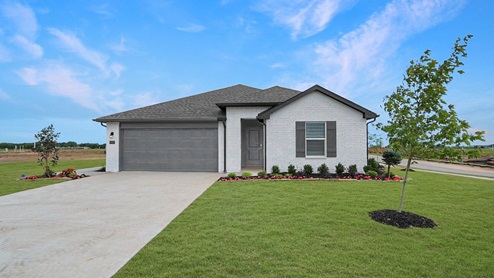 Exterior of one story brick home with two car garage