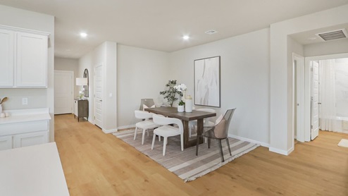 Interior dining area next to hallway and kitchen