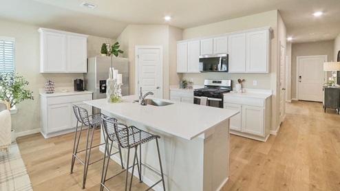 Interior of white kitchen with central island