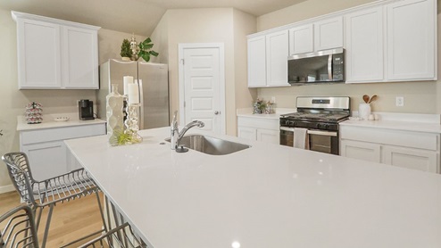 Interior of white kitchen with central island