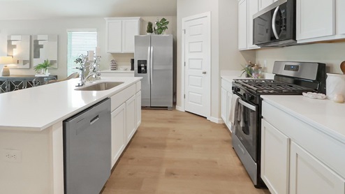 Interior of white kitchen with central island