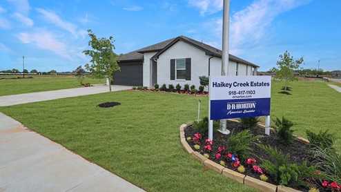 Exterior of one story brick home with two car garage