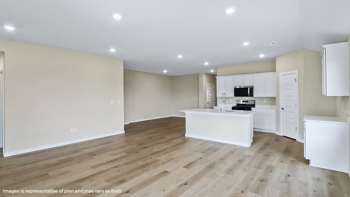 A well-organized living room that includes a kitchen and dining area, creating a warm and welcoming environment for gatherings.