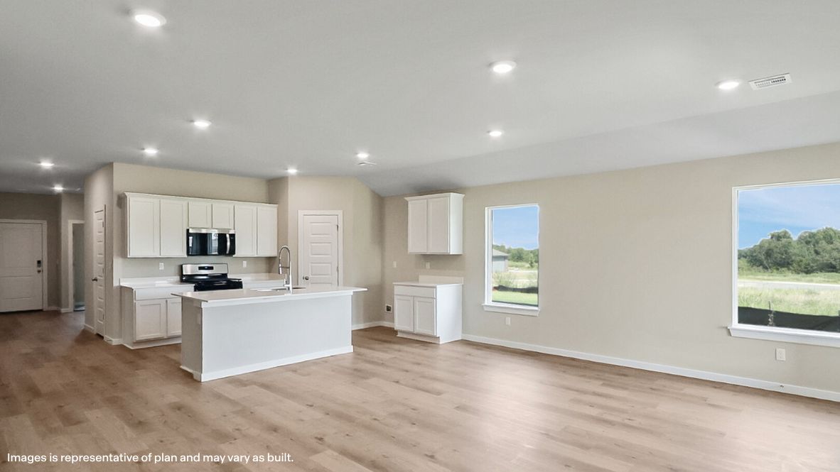 A well-organized living room that includes a kitchen and dining area, creating a warm and welcoming environment for gatherings.