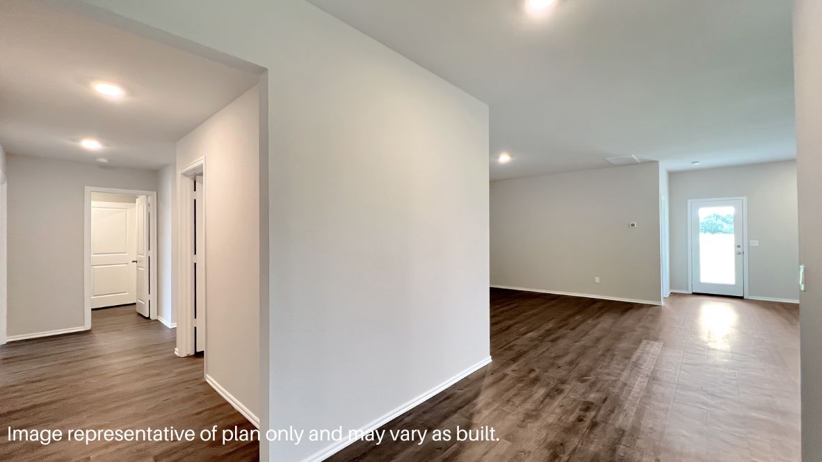 Entry hallway leading to living room and kitchen in the background.