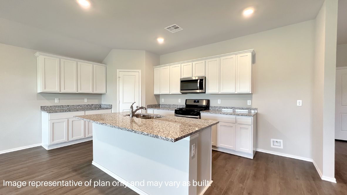 Bright and spacious kitchen with quartz countertops, stainless steel appliances, and an island with bar seating.