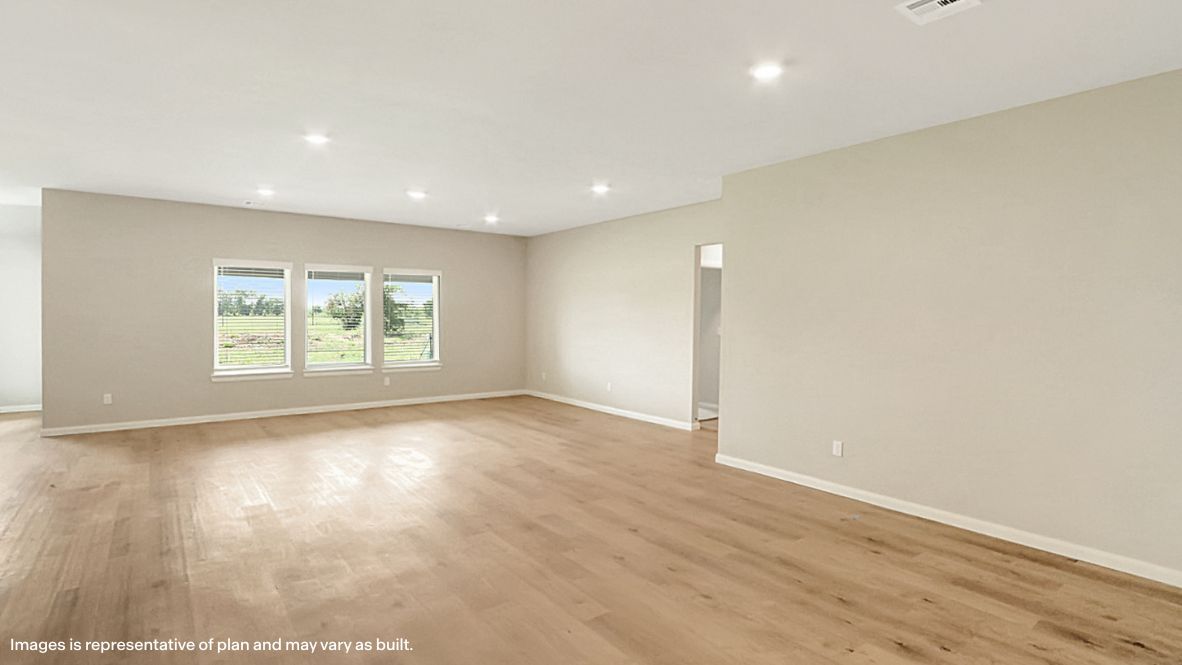 A well-organized living room that includes a kitchen and dining area, creating a warm and welcoming environment for gatherings.