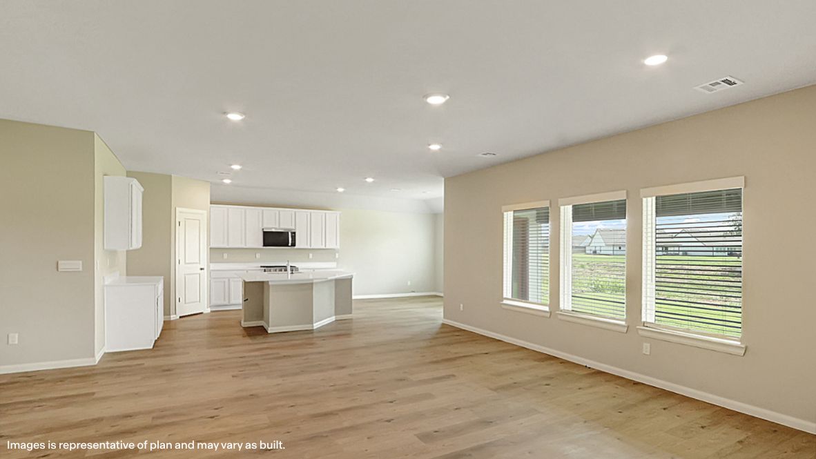 A well-organized living room that includes a kitchen and dining area, creating a warm and welcoming environment for gatherings.