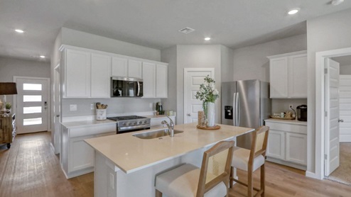 Interior of white kitchen with central island