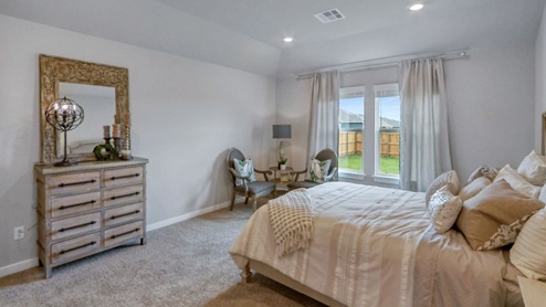 Interior of bedroom with two large windows
