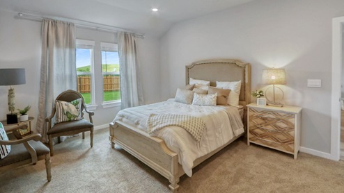 Interior of bedroom with two large windows