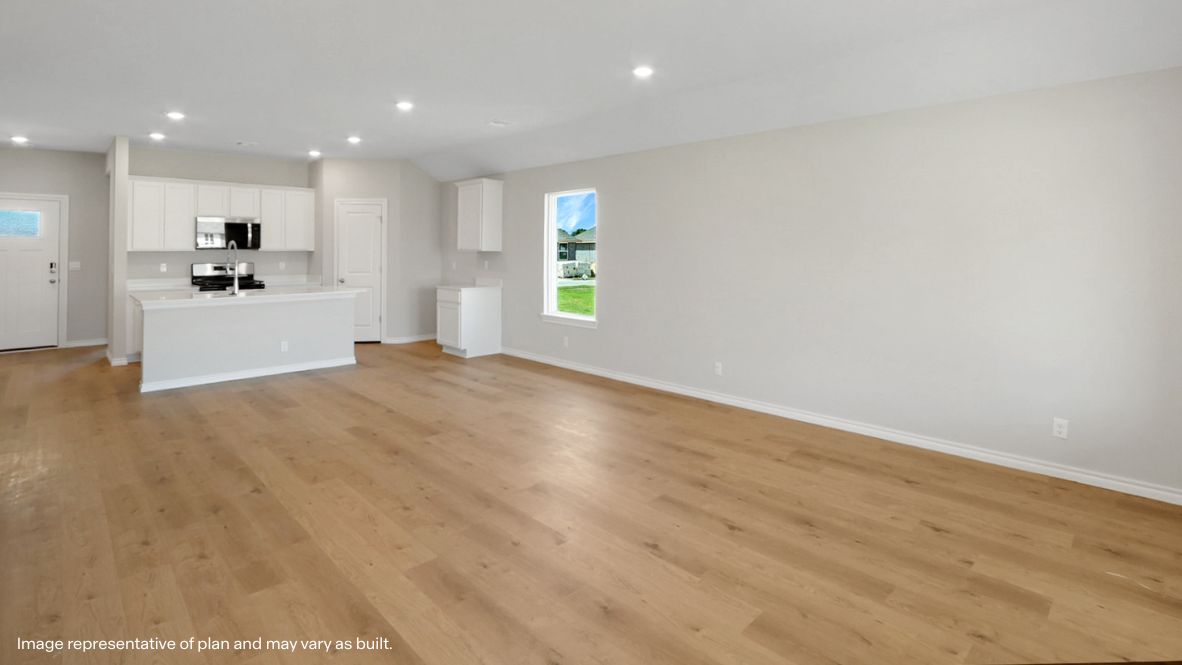 Looking from Living room to dining, kitchen and primary bedroom entrance  Cedars at the Preserve