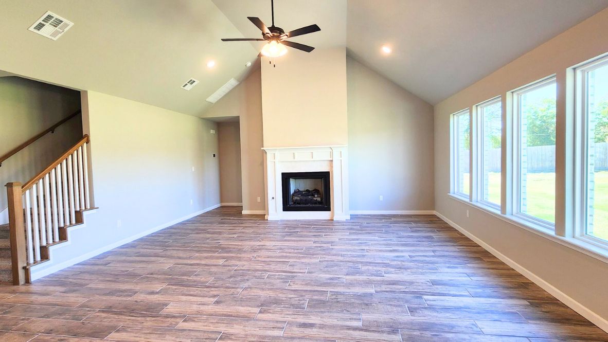 A well-organized living room that includes a kitchen and dining area, creating a warm and welcoming environment for gatherings.
