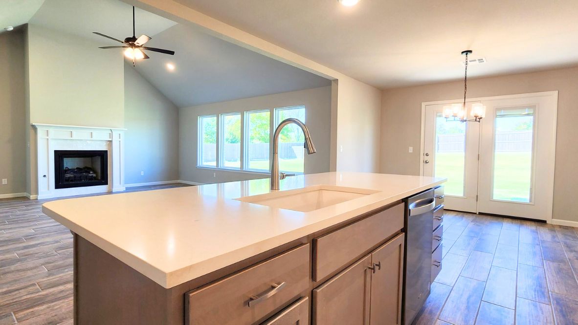 Contemporary kitchen adorned with white cabinets seamlessly integrated into an open dining area layout.