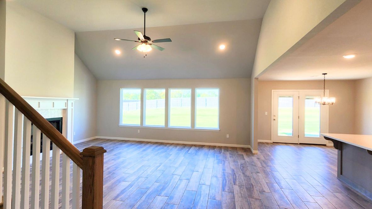 Living room: A well-organized living room that includes a kitchen and dining area, creating a warm and welcoming environment for gatherings.