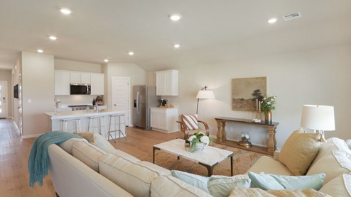 Interior of living room looking into the kitchen