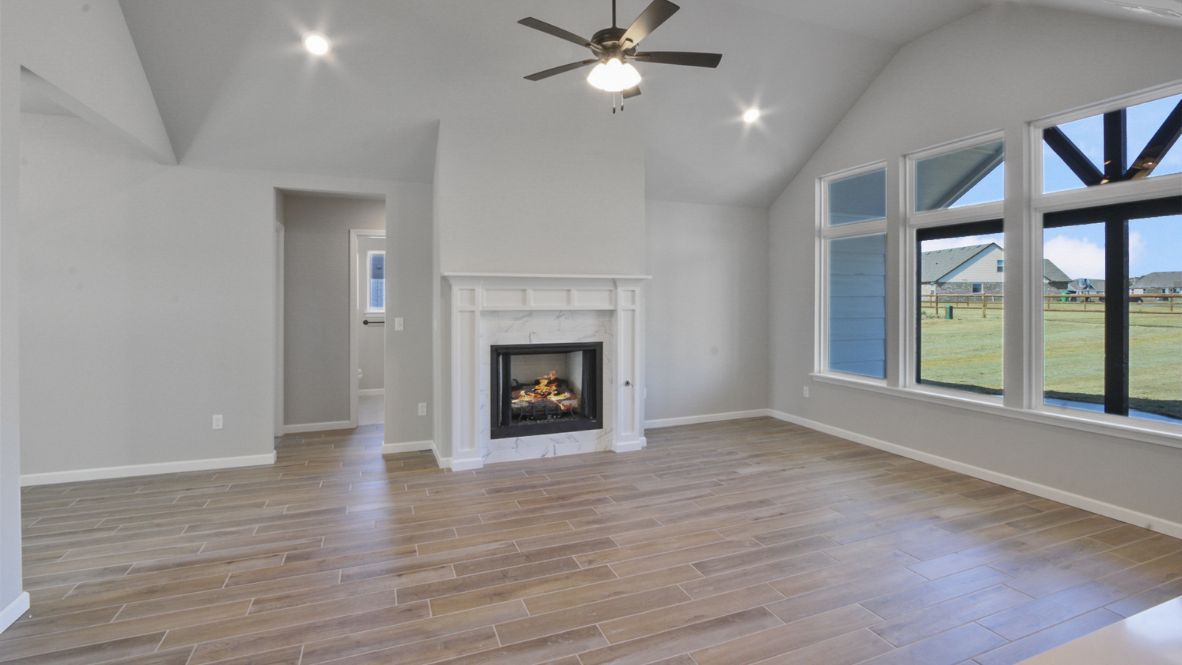 A well-organized living room that includes a kitchen and dining area, creating a warm and welcoming environment for gatherings.