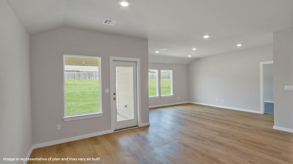 A well-organized living room that includes a kitchen and dining area, creating a warm and welcoming environment for gatherings.