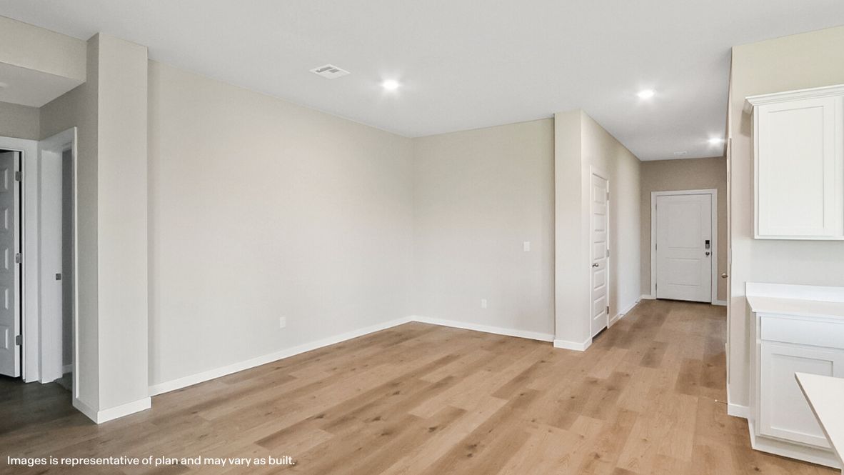 Spacious dining area with vinyl wood flooring, large window and tall ceiling.
