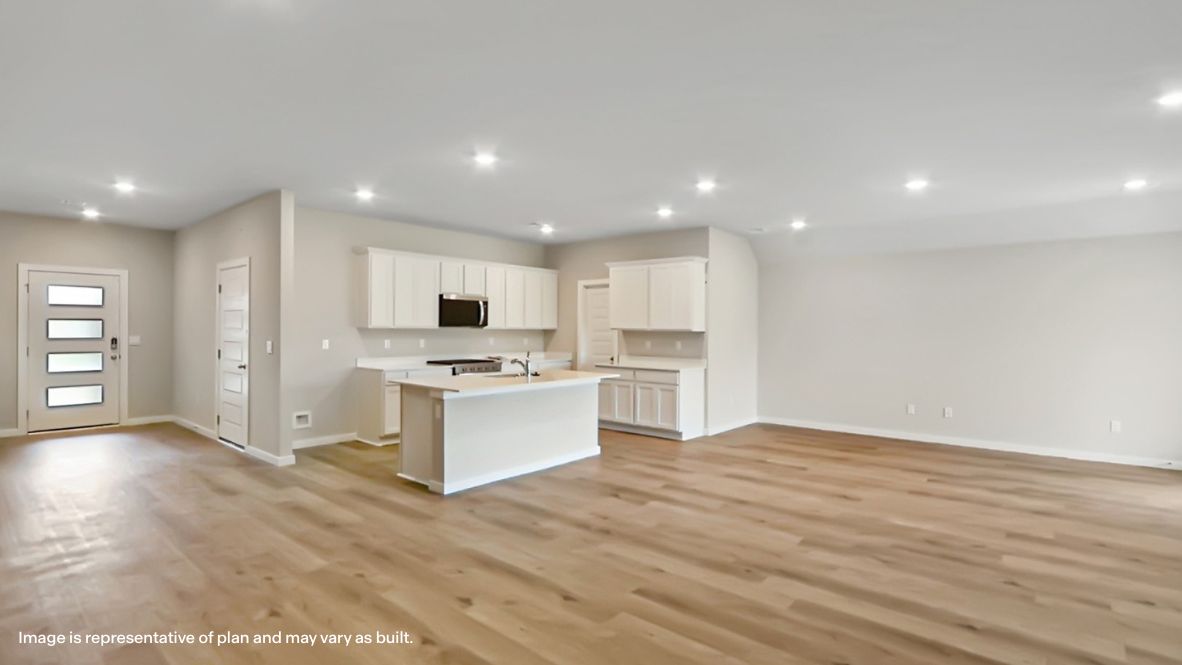 A well-organized living room that includes a kitchen and dining area, creating a warm and welcoming environment for gatherings.