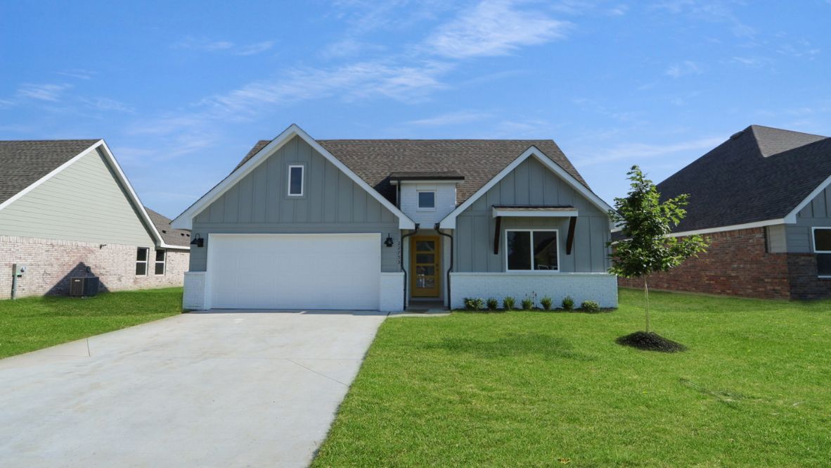 Front elevation of the Cali Plan with landscaped front yard and driveway approach
