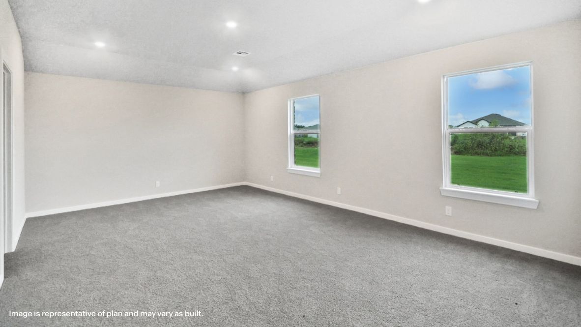 View from living room into dining, kitchen, and primary bedroom entrance Rowan Grove