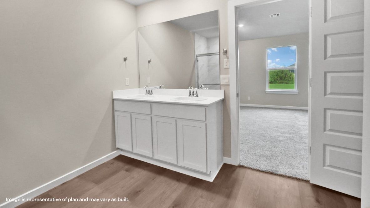Owner’s ensuite with vanity and view back into the primary bedroom