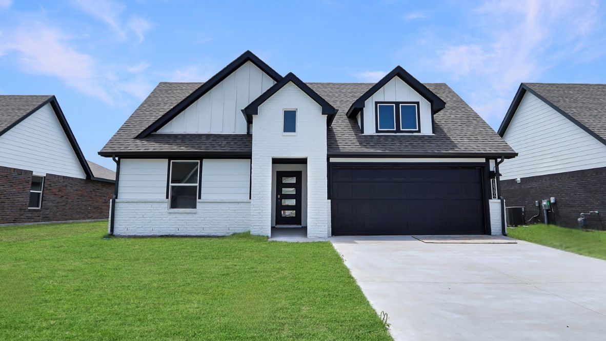 Street view of white exterior elevation with driveway and front windows