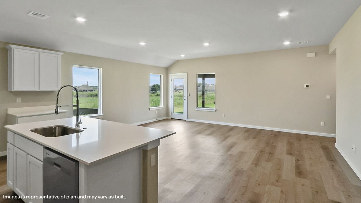 A well-organized living room that includes a kitchen and dining area, creating a warm and welcoming environment for gatherings.