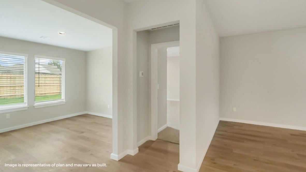 A well-organized living room that includes a kitchen and dining area, creating a warm and welcoming environment for gatherings.