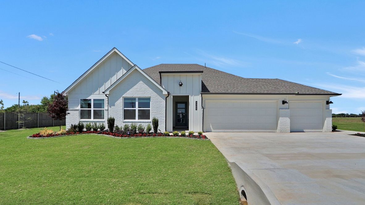 Street view showcasing Holden Plan’s 3-car garage, front yard, and clean exterior design Rowan Grove