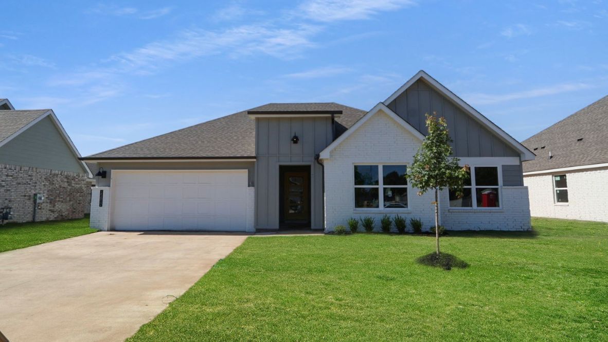 Sidewalk view featuring front façade, windows, and landscaped walkway