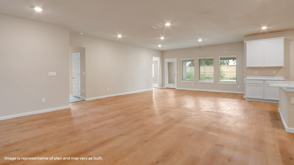 Wide view into kitchen, dining, living, and outdoor areas showing connected layout