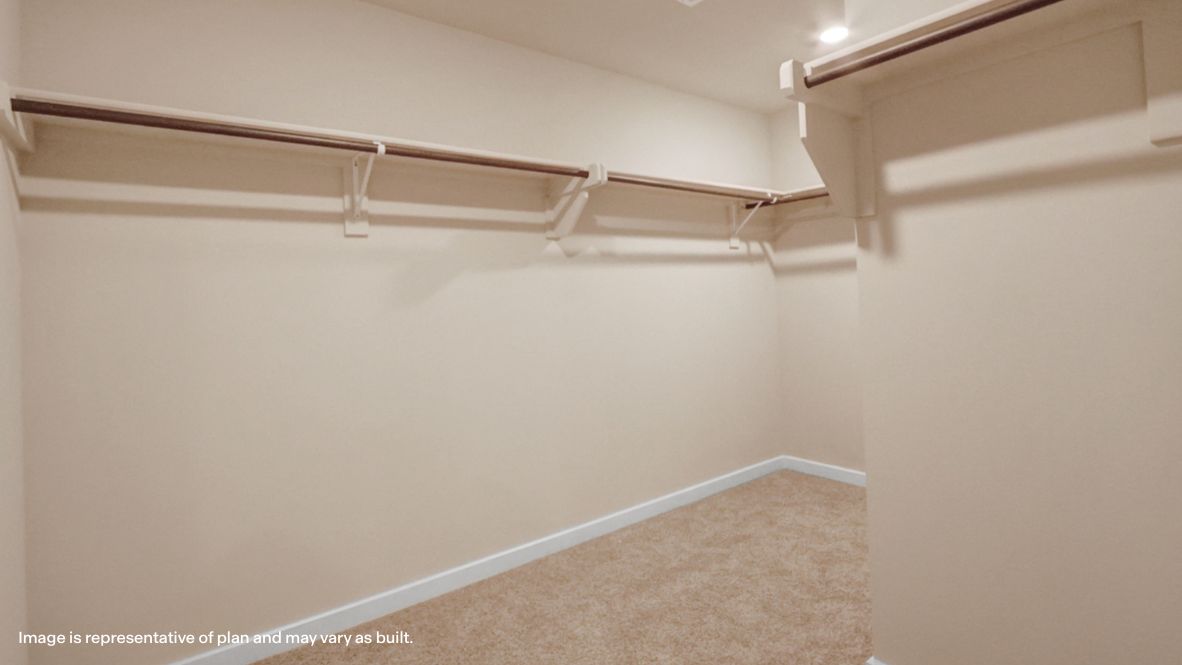 Primary walk-in closet with shelving and organized storage space Rowan Grove