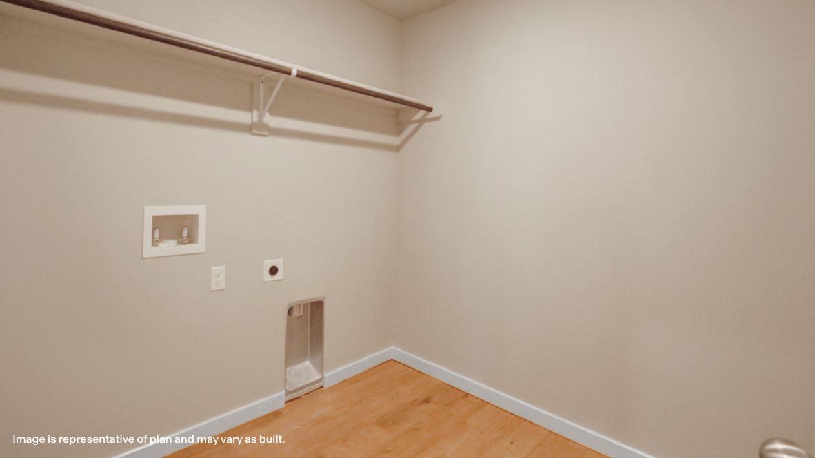 Utility laundry with washer-dryer hookups, storage space, and clean finishes