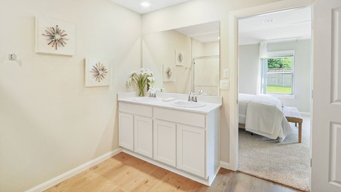 Interior bathroom with vanity off of primary bedroom