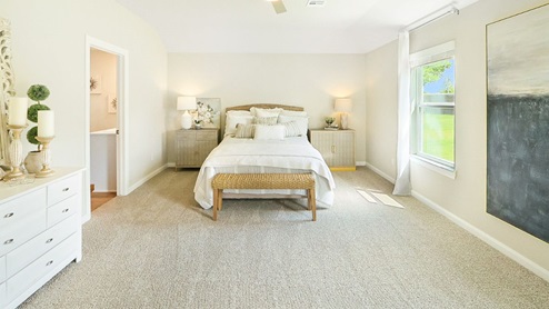 Interior bedroom with large window and private bathroom
